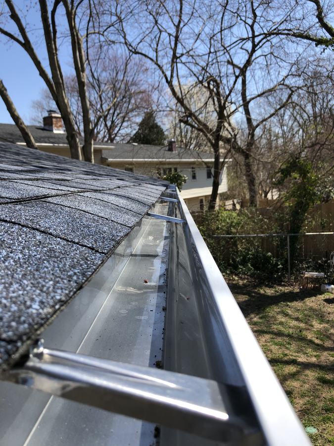 Looking down a new gutter run with the inner hangers visible